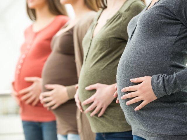 Pregnant women lined up in a row